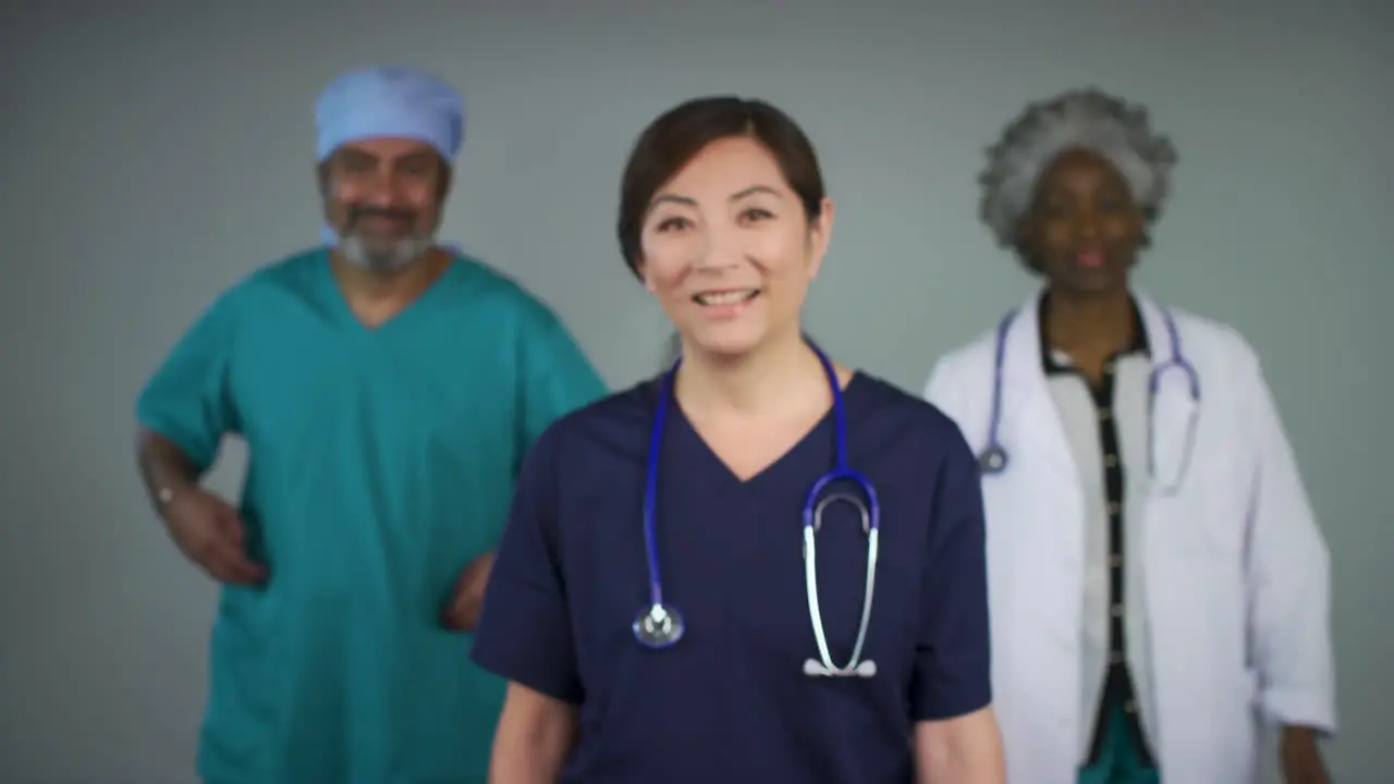 Pull Focus of Three Middle Aged Doctors Smiling Portrait