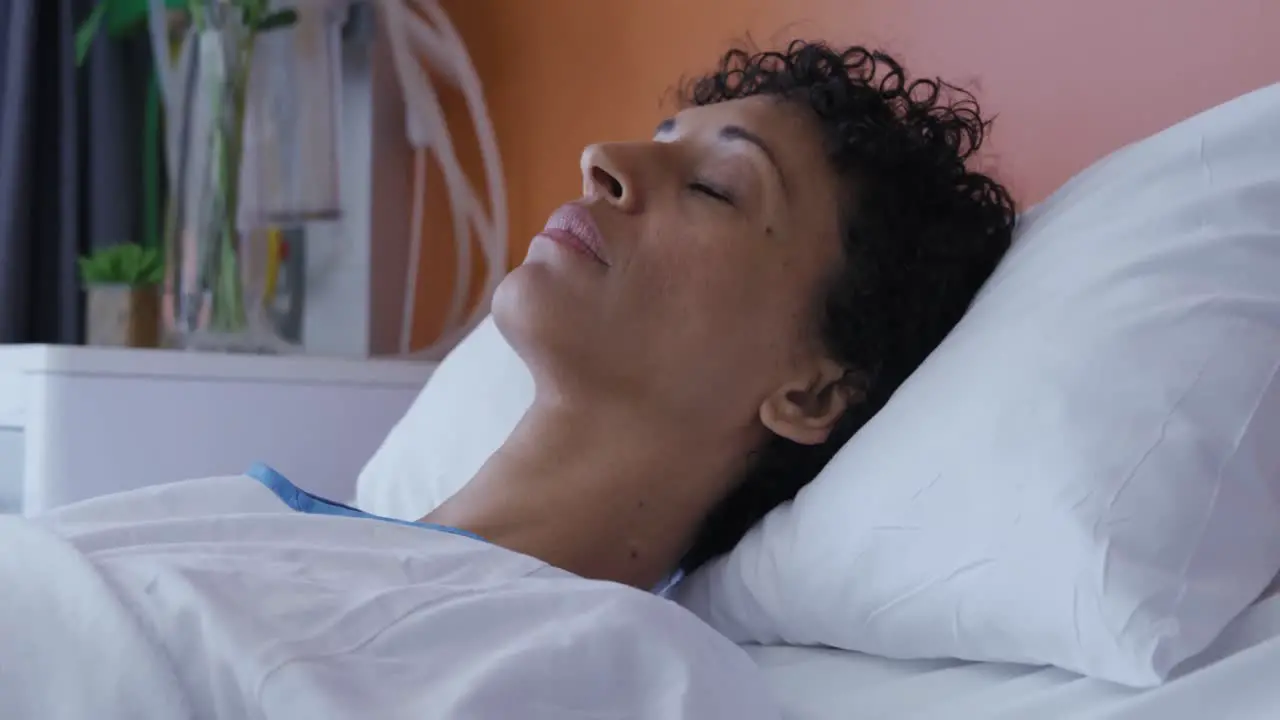 Female patient lying in a hospital bed