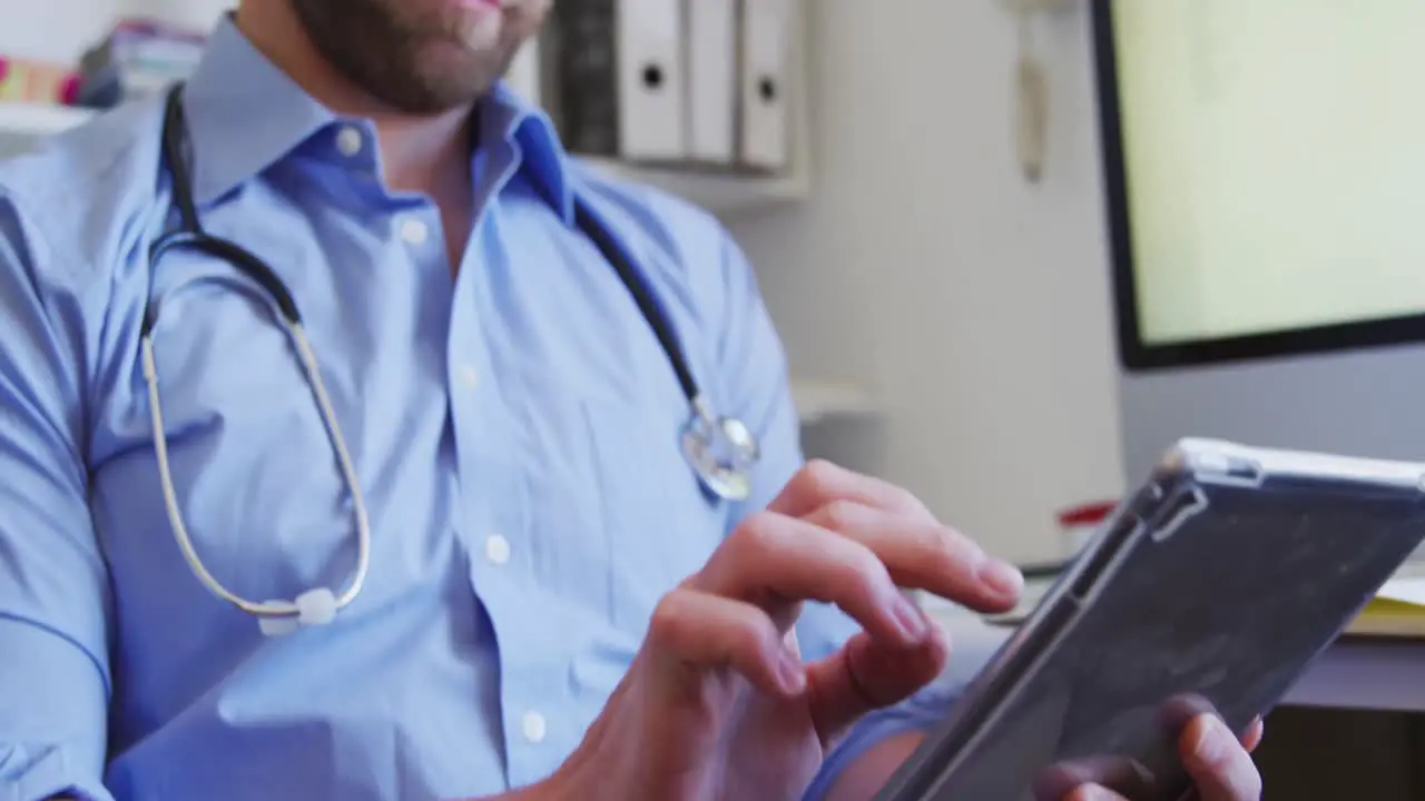 Doctor working and using digital tablet in a retirement home