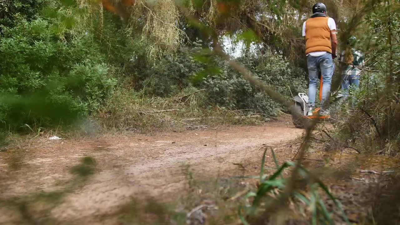 Tourists ride a Segway scooter through forest