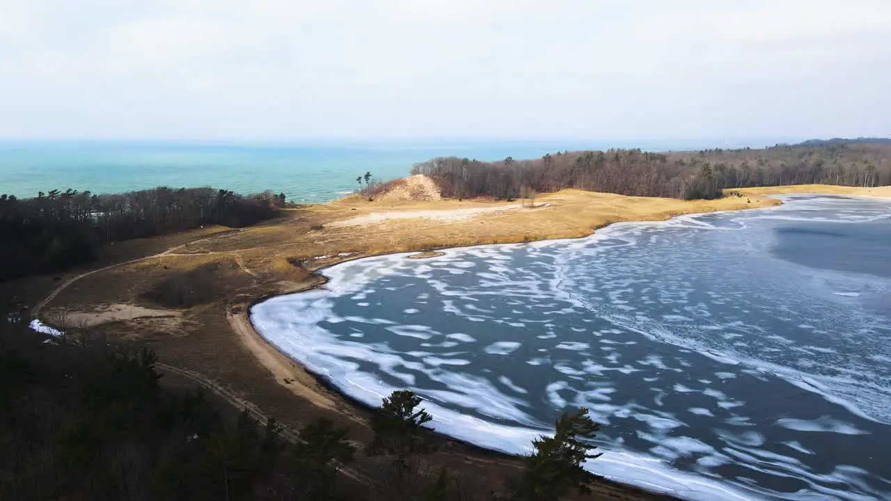 Pulling back and lowering over Dune Harbor near Lake Michigan