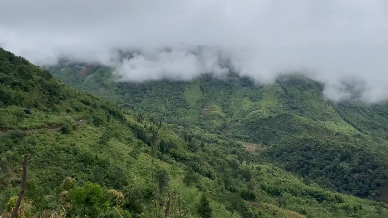 Clouds And Fogs Over Lush Green Forest And Mountain Hills In India