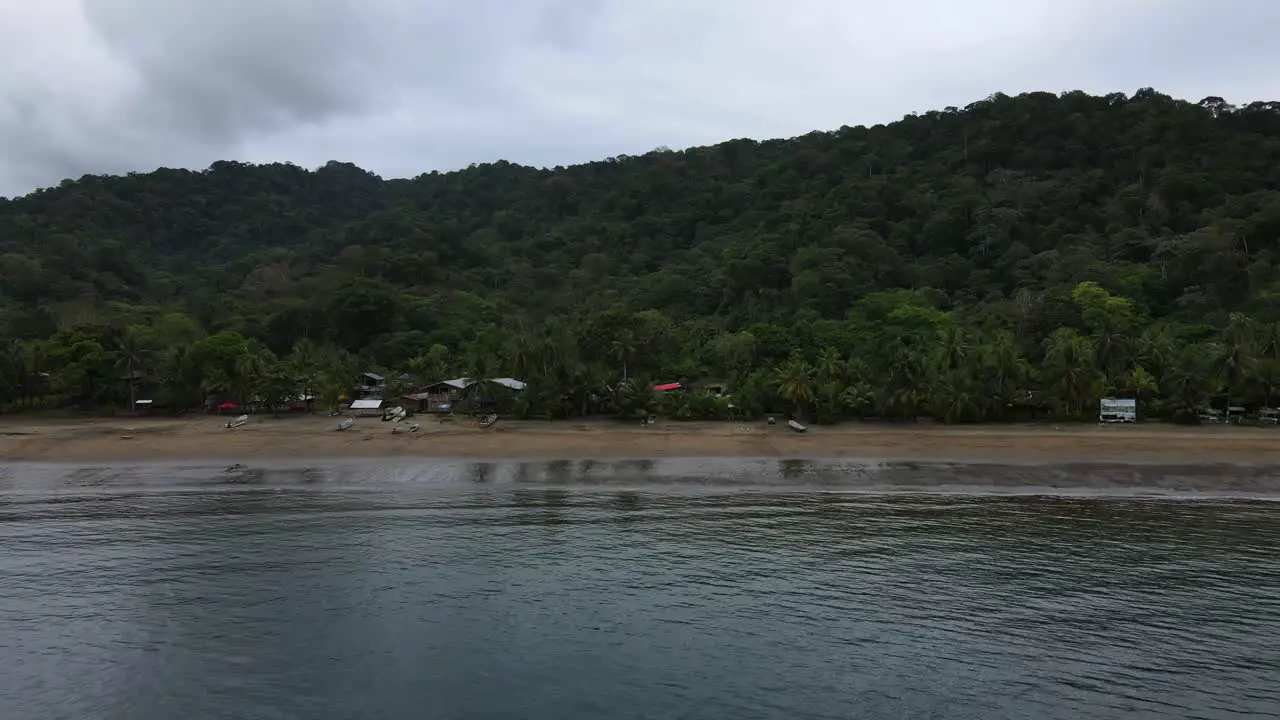 Drone shot of island Bahia Solano Colombia flying backwards exposing the island