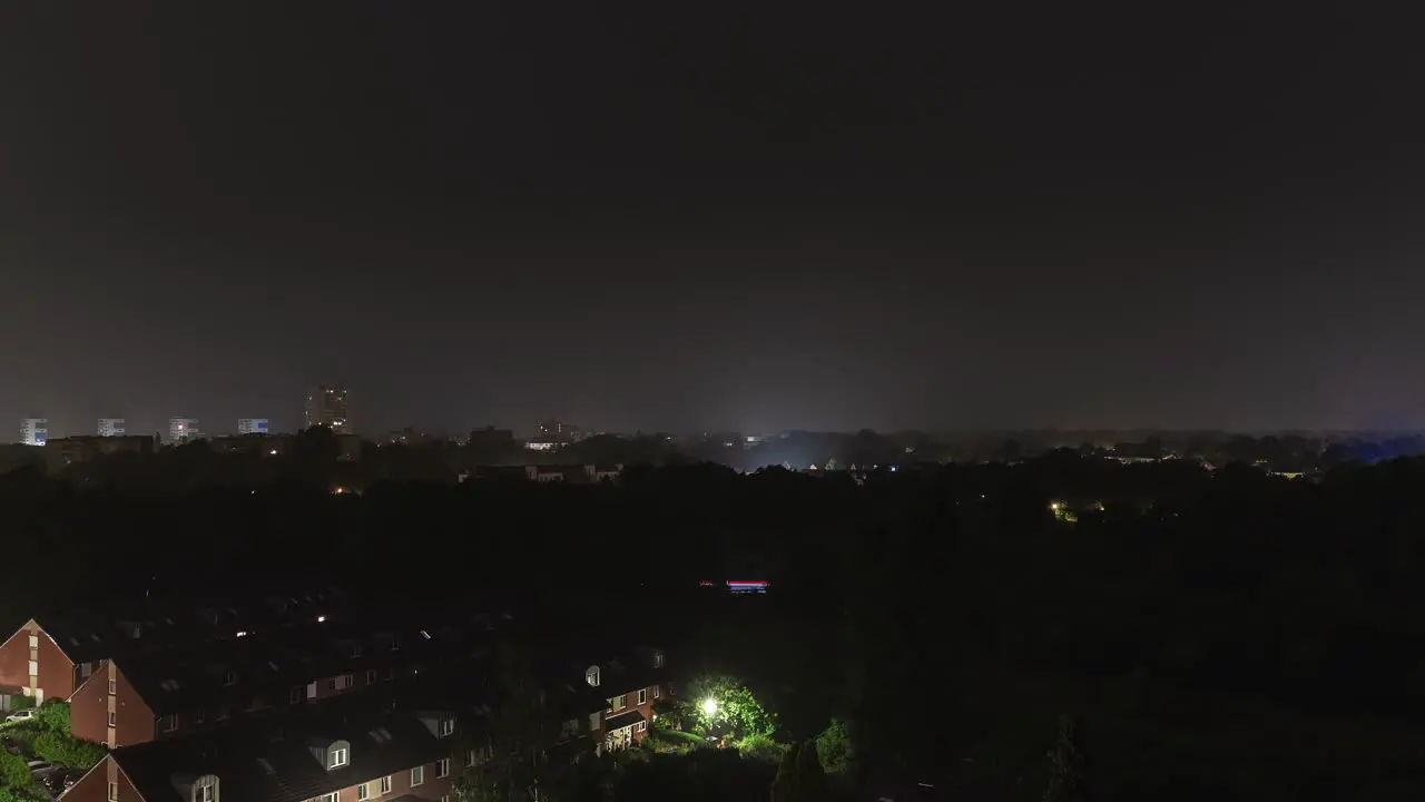 Time lapse sequence of thunderstorm lightning at night over a village