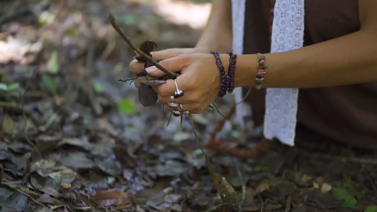 Beautiful woman caressing and holding the earth and the leaves of the trees with her hands connecting embracing and loving the nature of the planet