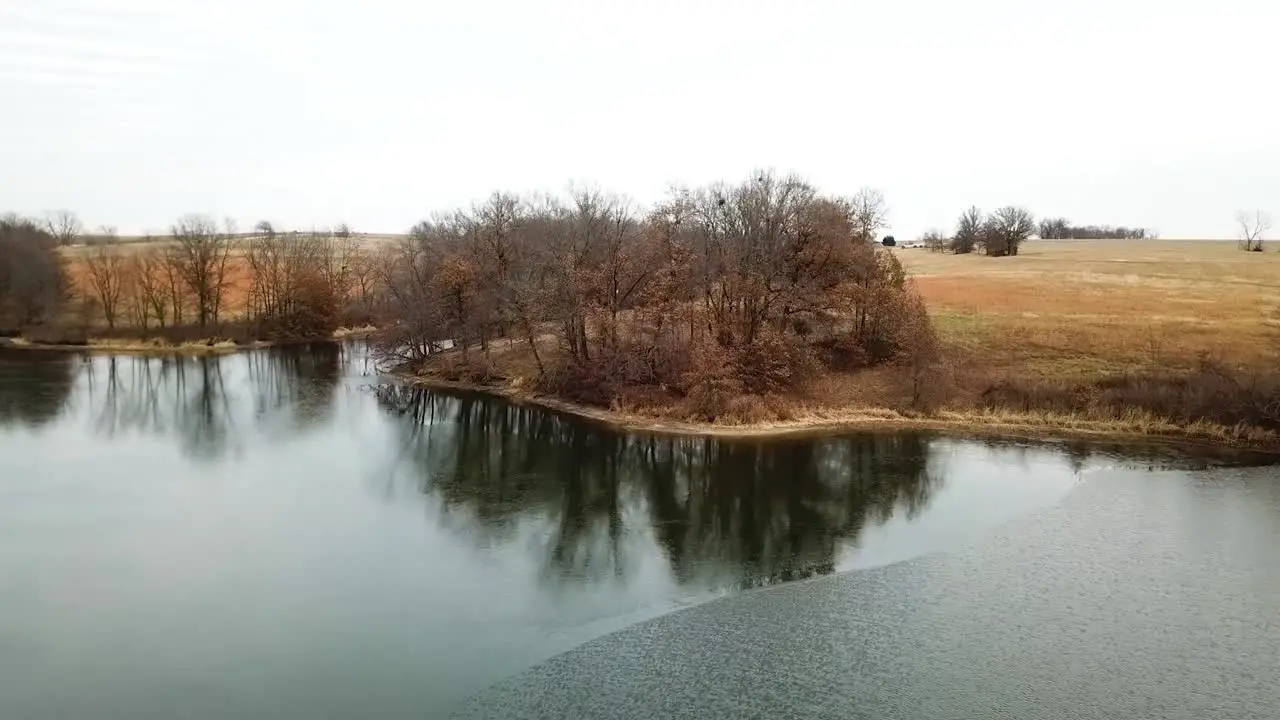 Flying over huge lake in massive empty fields