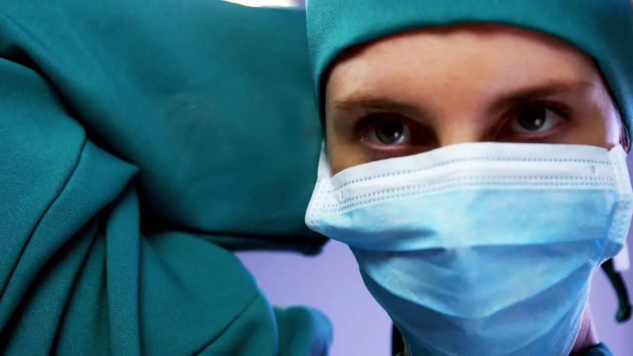 Female surgeon wearing surgical mask in operating room