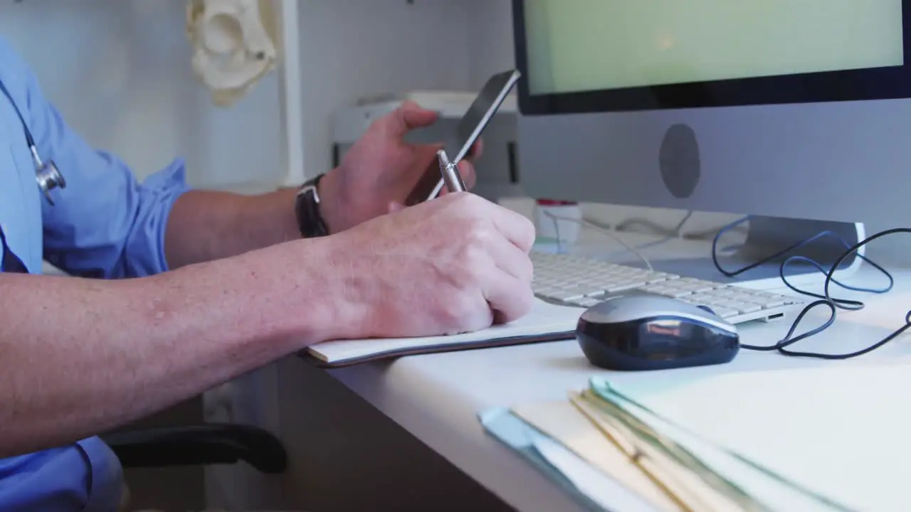 Doctor working and using smartphone in a retirement home