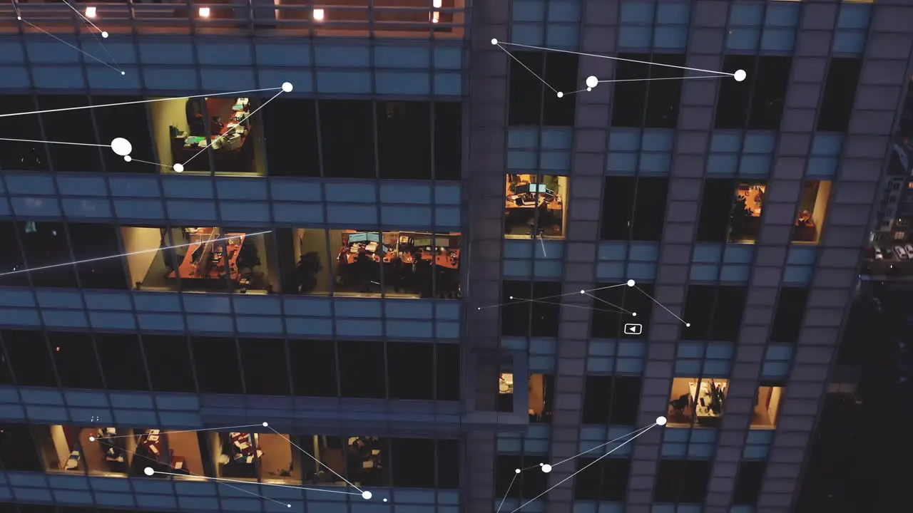 Ascending footage of modern office building View through windows on people working in evening Added computer graphic of cooperation connection and communication