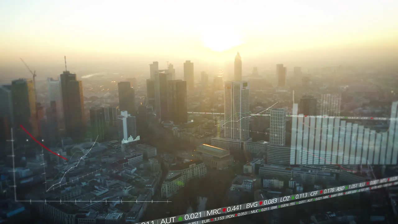 Aerial panoramic view of high rise business downtown buildings against glowing sunset sky Added computer graphics with charts and financial figures Frankfurt am Main Germany