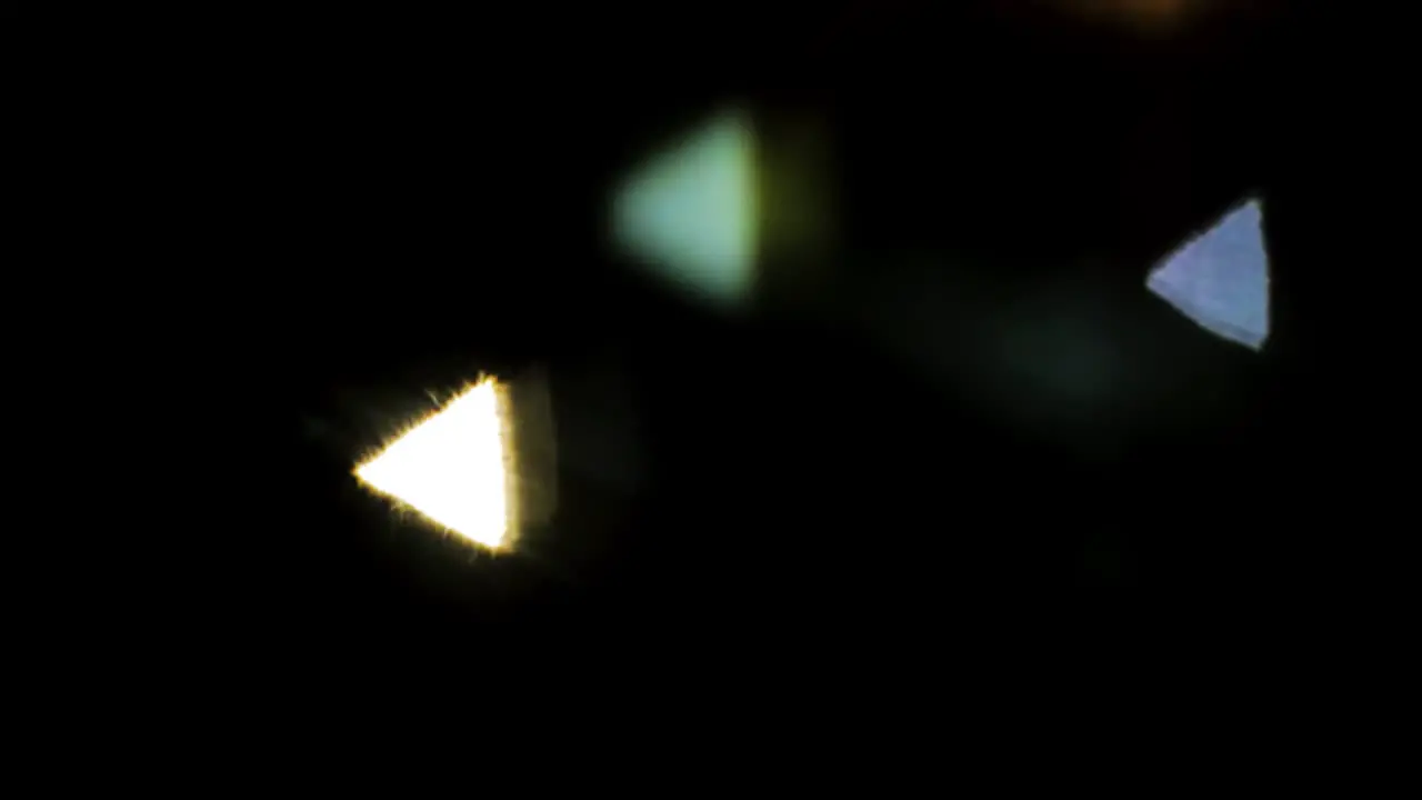 Abstract PINHOLE camera triangle bokeh follow car head and tail lights at night in slow motion colorful black