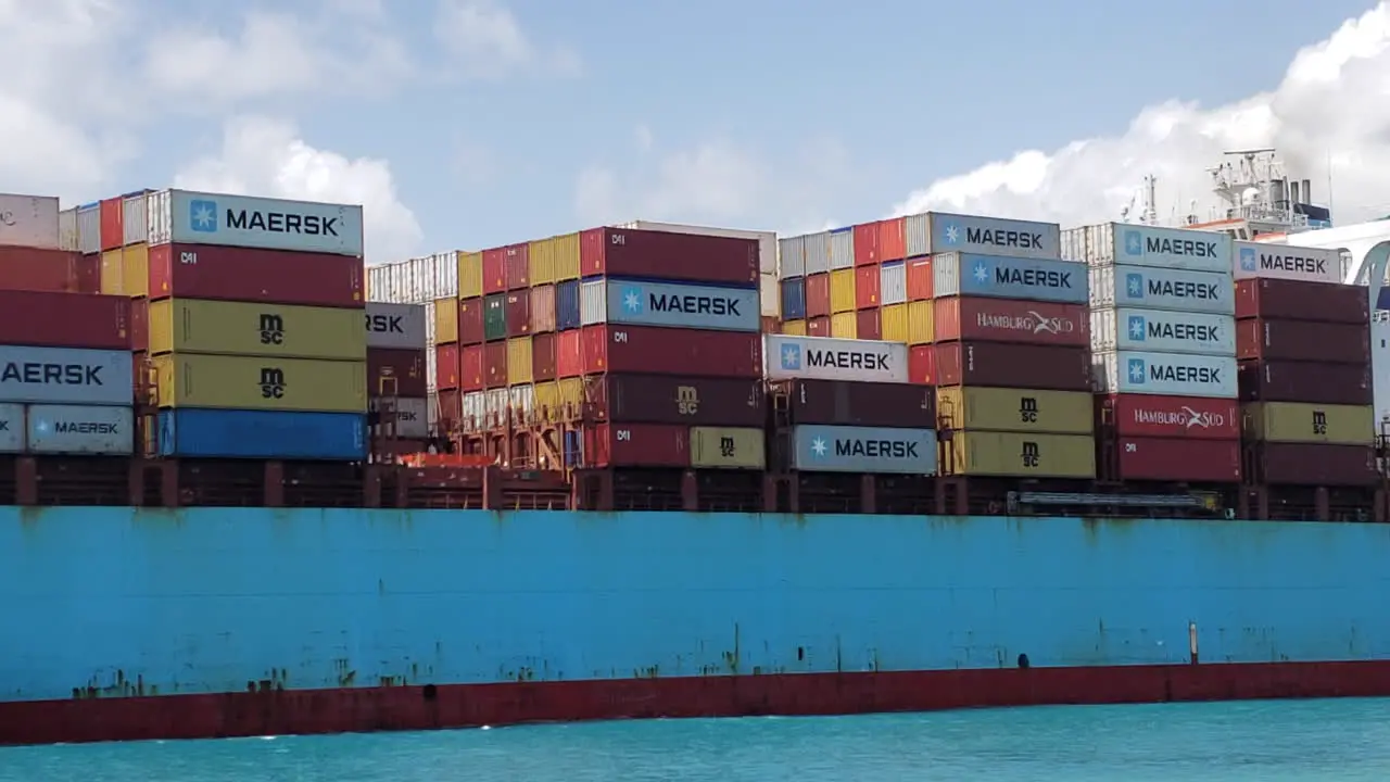 Big cargo ship heading out to sea close up