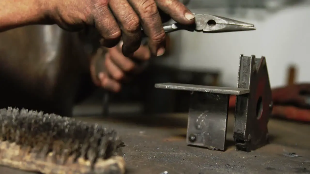 Hands of welder working on a piece of metal