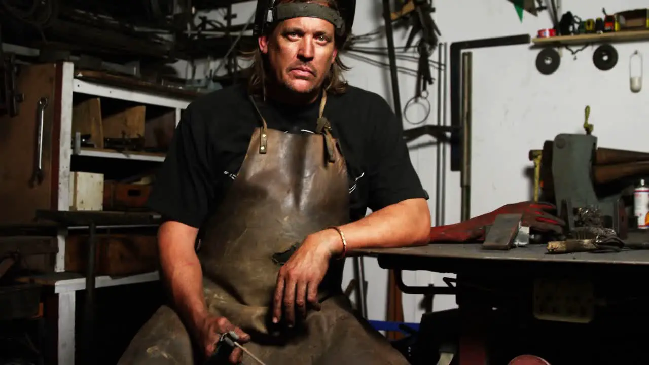 Portrait of welder sitting with welding arch