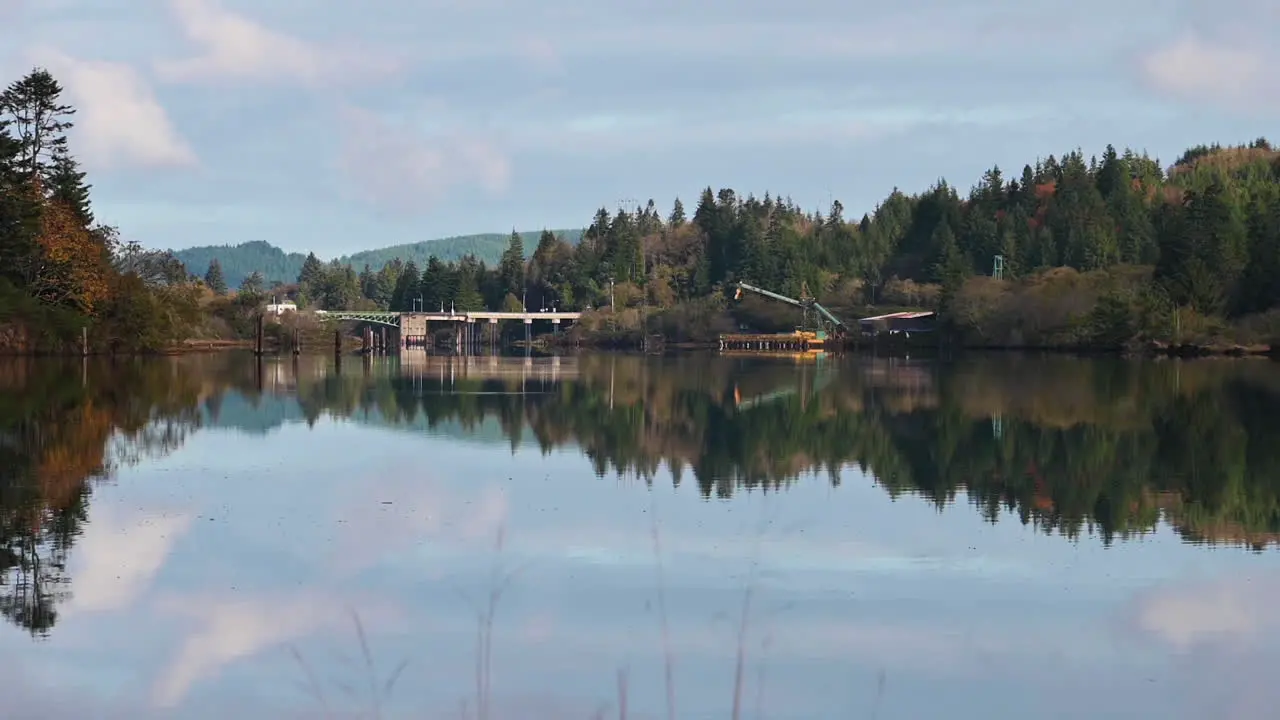 Lumber Mill Near Bridge In Coos Bay Oregon With Water Reflections wide static shot