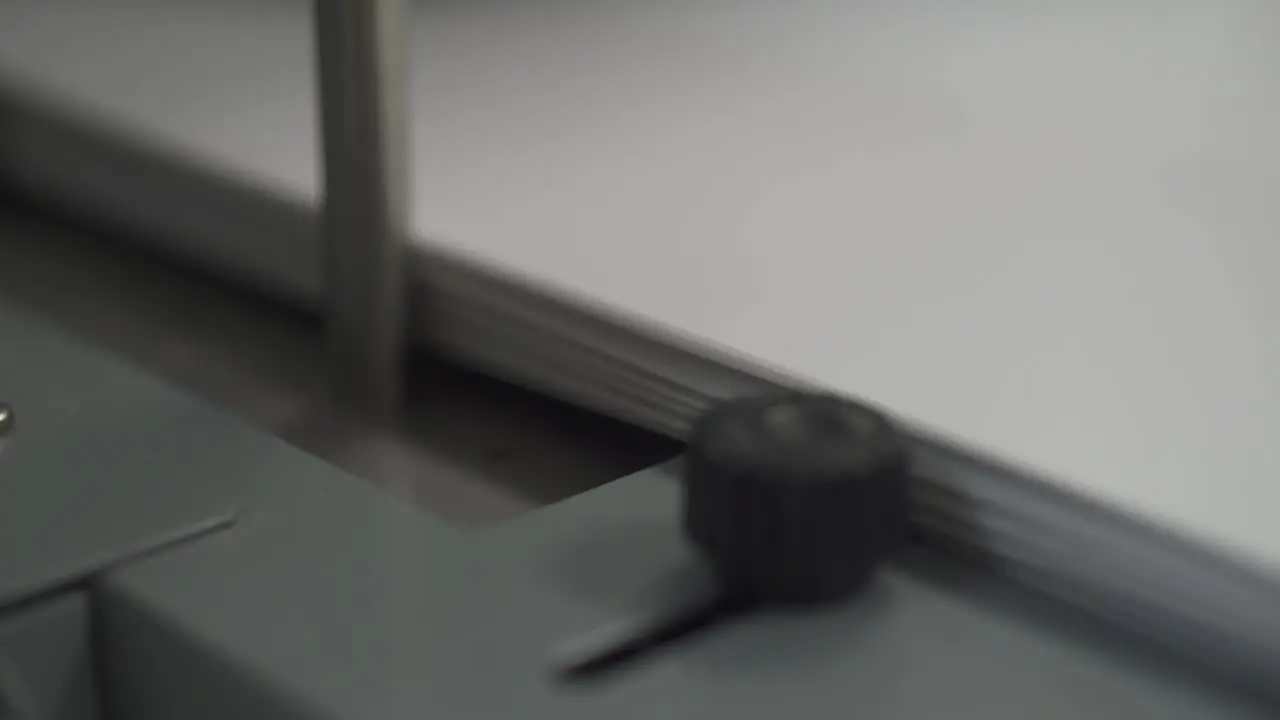 An industrial printer passes paper and film