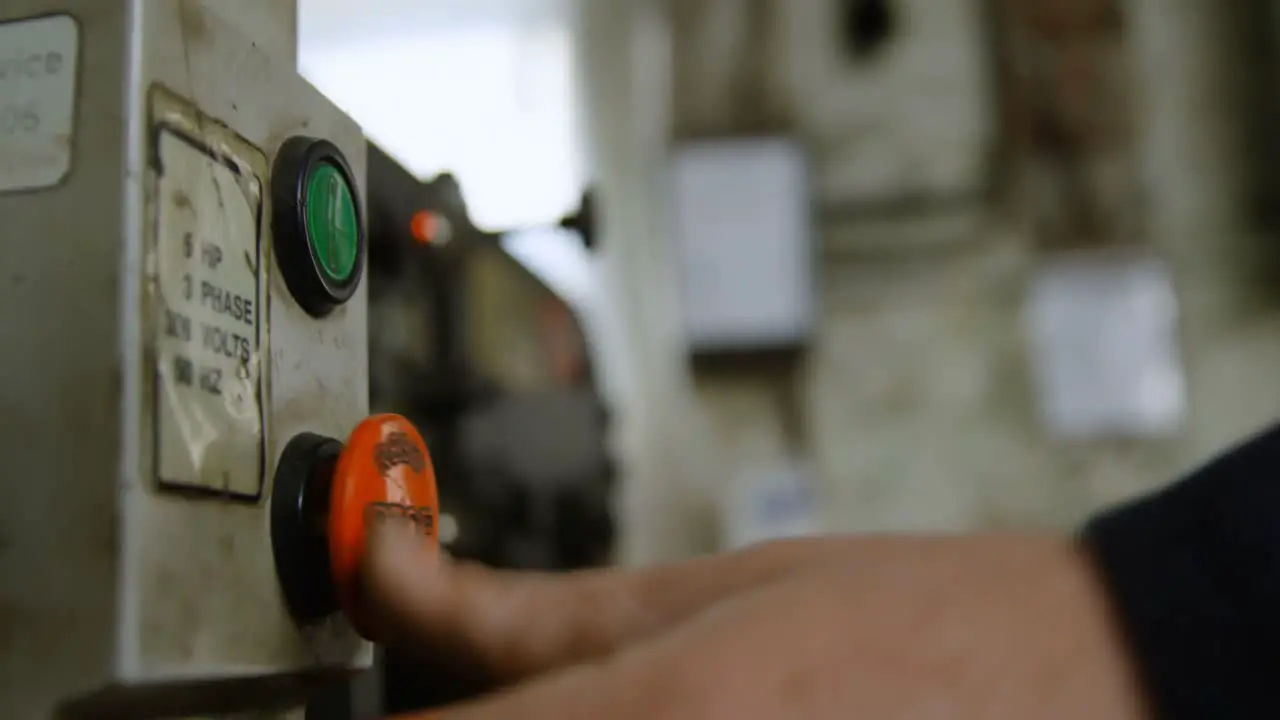 Metalsmith operating a machine in workshop 4k