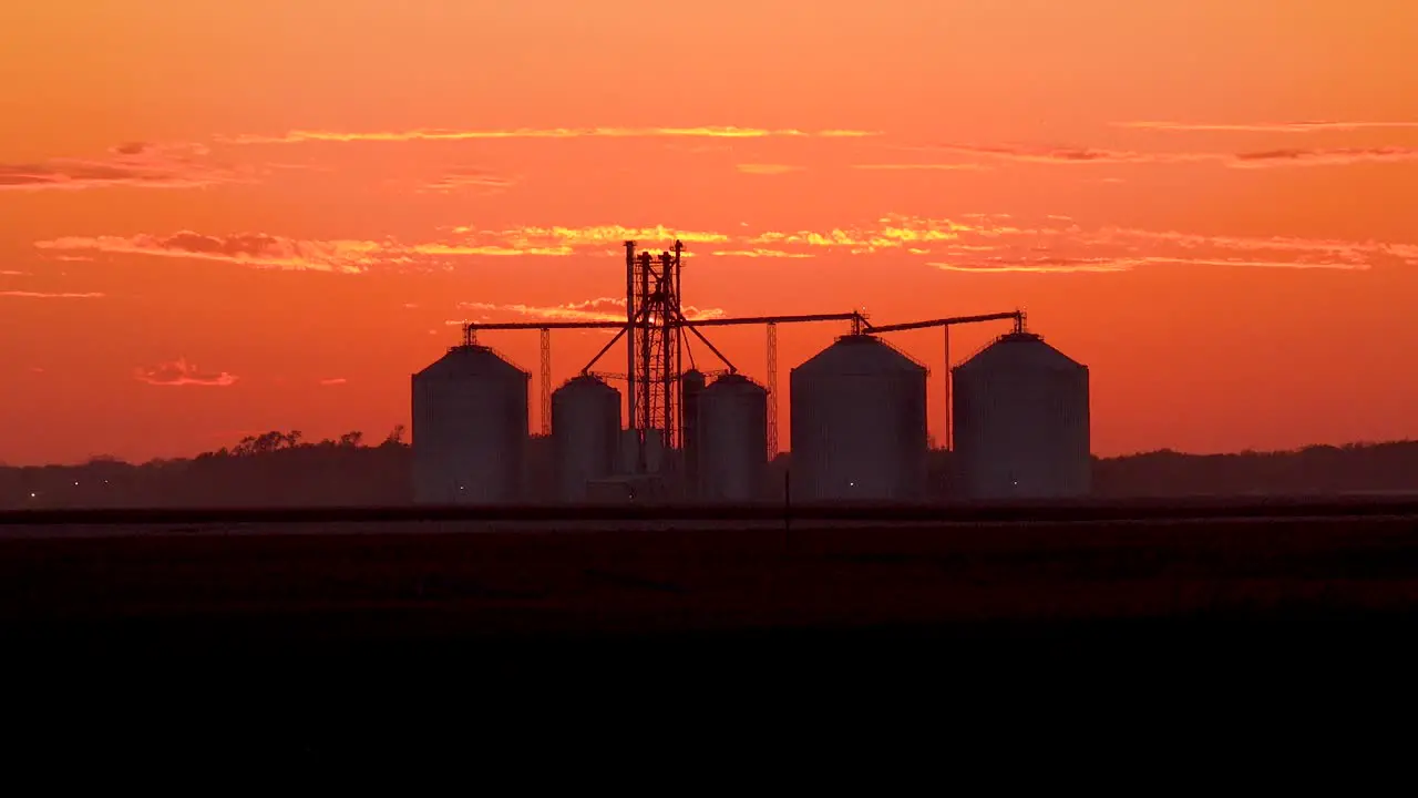 Grain Silos On A Large Commercial Farm At Dusk In The Midwest