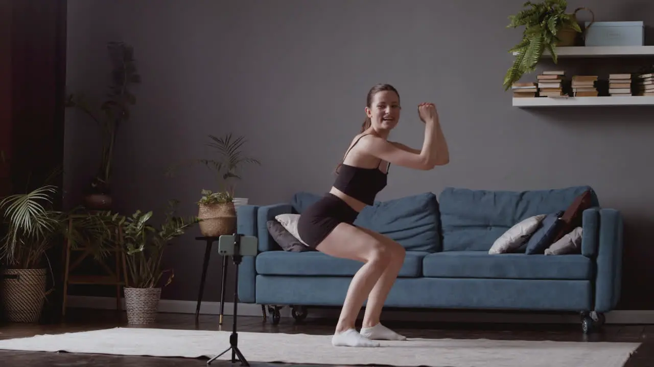 Wide Shot Of An Exultant Athletic Young Woman Giving An Online Fitness Lesson 1