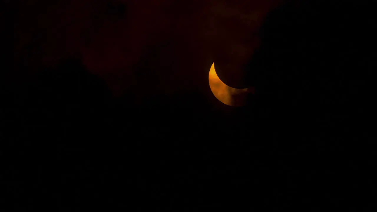 A partially eclipsed sun is revealed by the clouds annular solar eclipse October 14th 2023