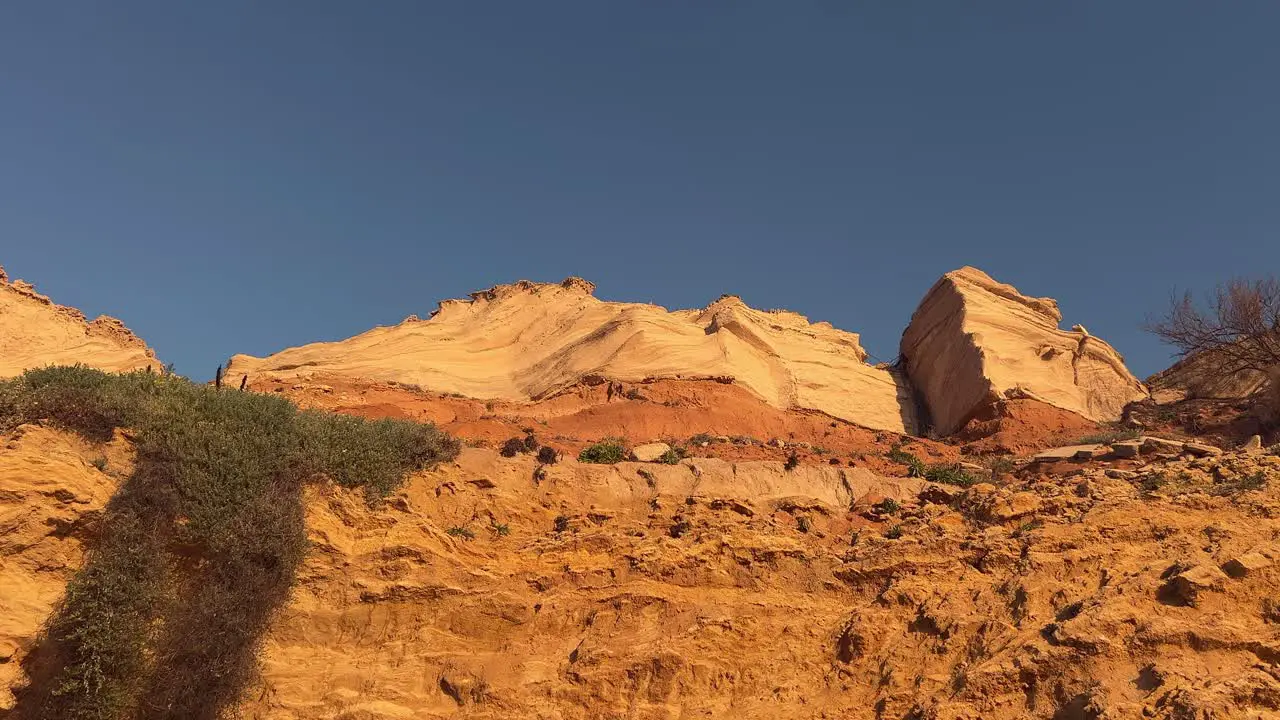 trucking left on sunny cliffs and vegetation at sunset