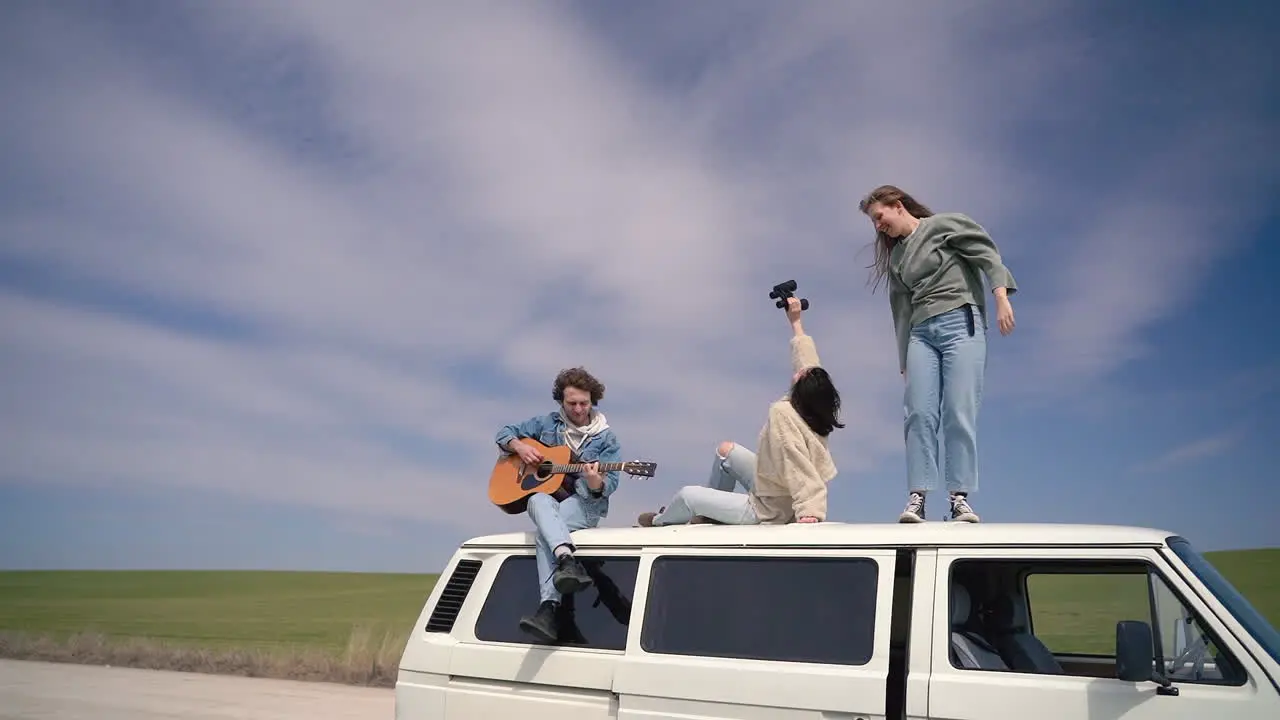 A Group Of Teenagers In A Caravan On A Road Lost In The Middle Of The Countryside 1