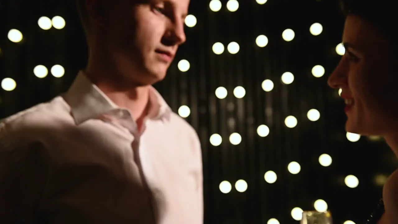 Young Man And Woman Dance And Drink Glass Of Champagne At A New Year's Eve Party