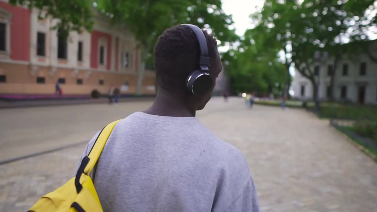 Rare View Of Young Tourist Listening To Music Using Headphones And Smart Phone Walk In Beautiful Old City