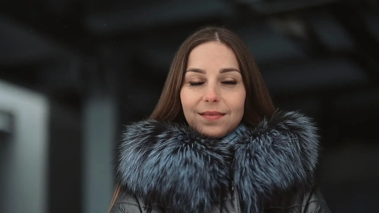 Portrait Of Woman Looking At Camera Posing In Winter Clothes And Smiling