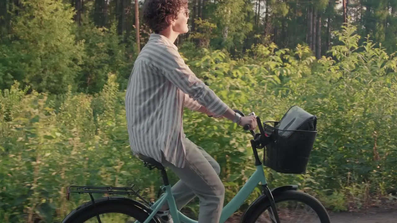 Young Happy Woman In Sunglasses And Casual Clothes Riding A Bike In Forest Path 1