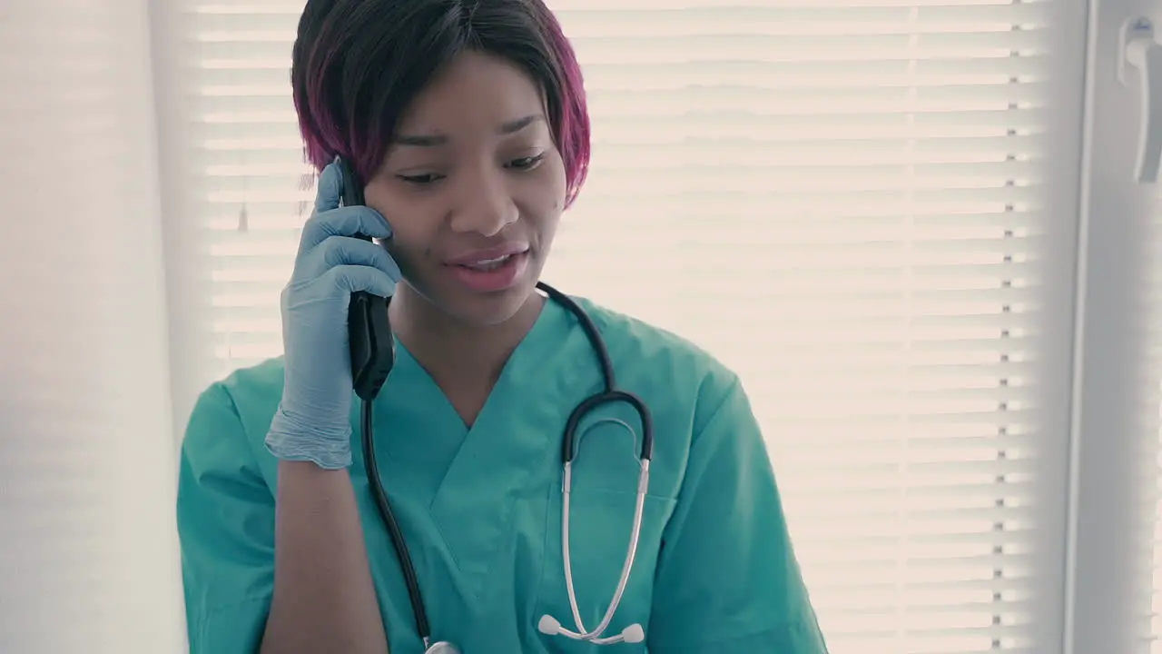 A Beautiful Young Female Nurse Talking On The Cellphone