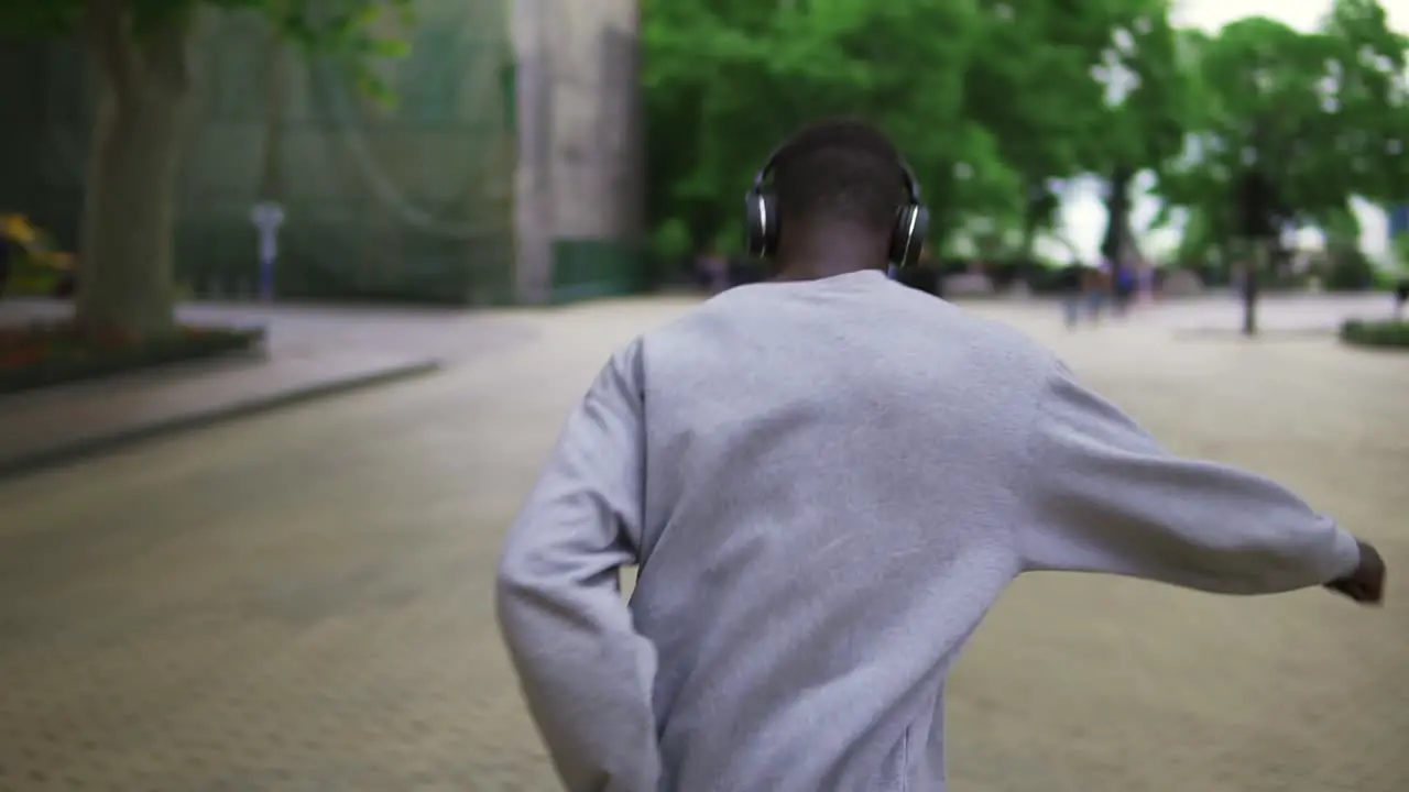 Slow Motion Of Joyful Guy In Casual Clothing Dancing Freerly Moving In Headphones Outdoors Having Fun In City Alone Smiling Carefree 1