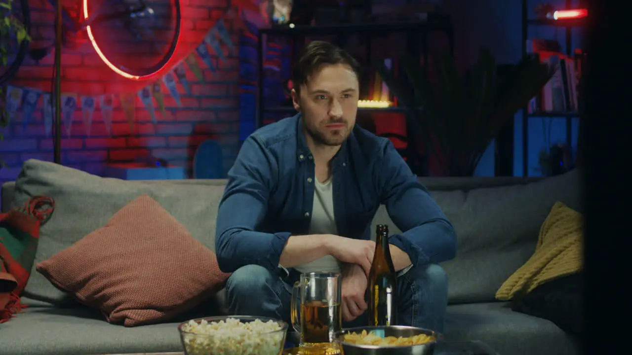 Handsome Of The Young Man Watching Tv At Night And Drinking Beer Sport Fan Watching A Game