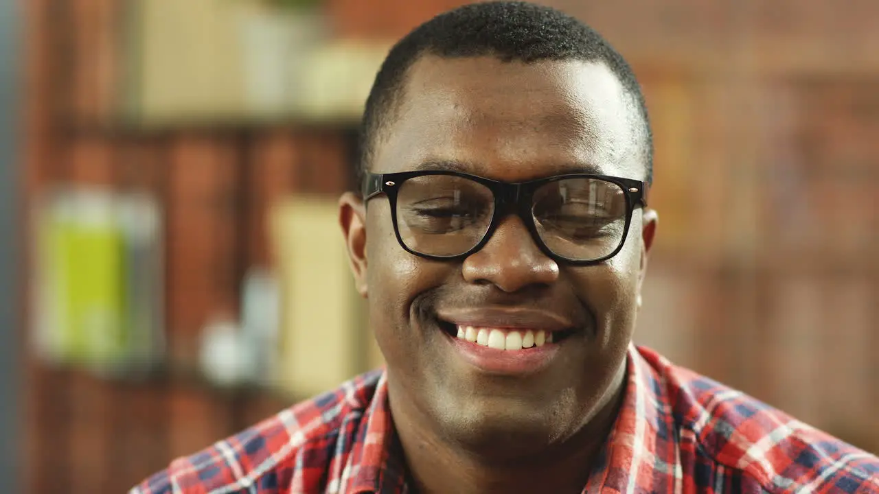 Portrait Of The Cheerful Man In Glasses Smiling To The Camera