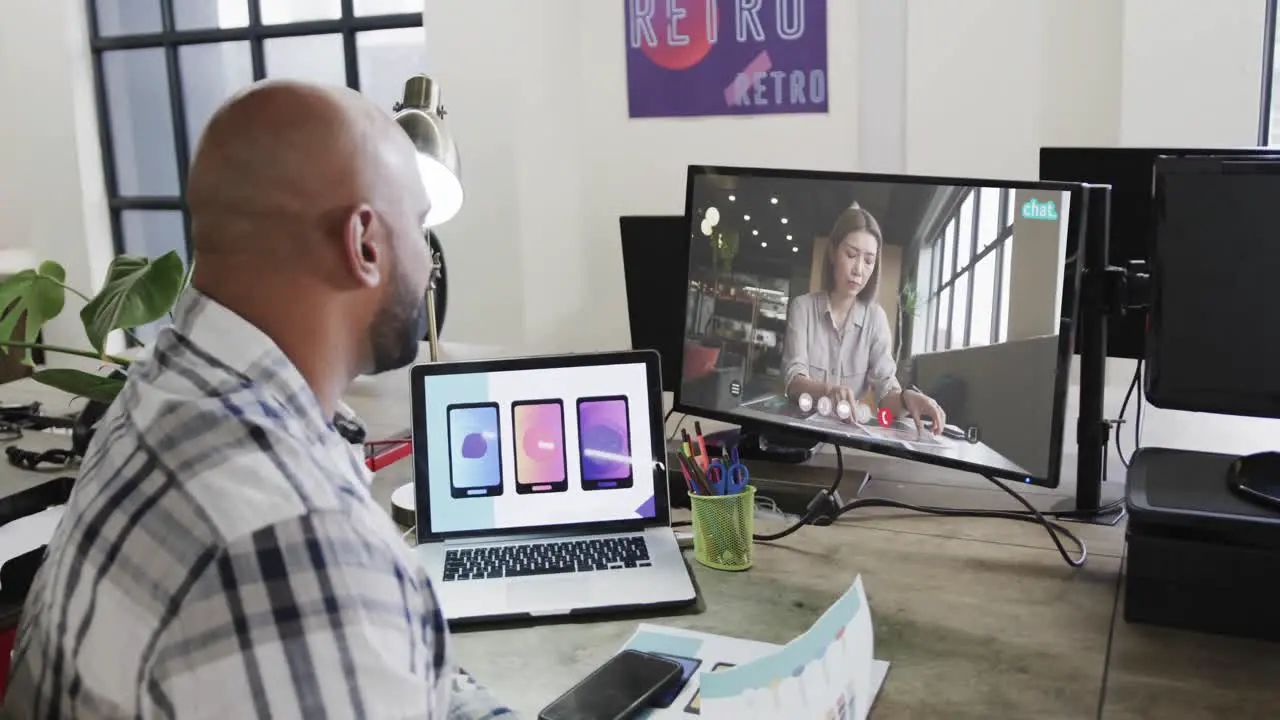 African american businessman on video call with caucasian female colleague on screen