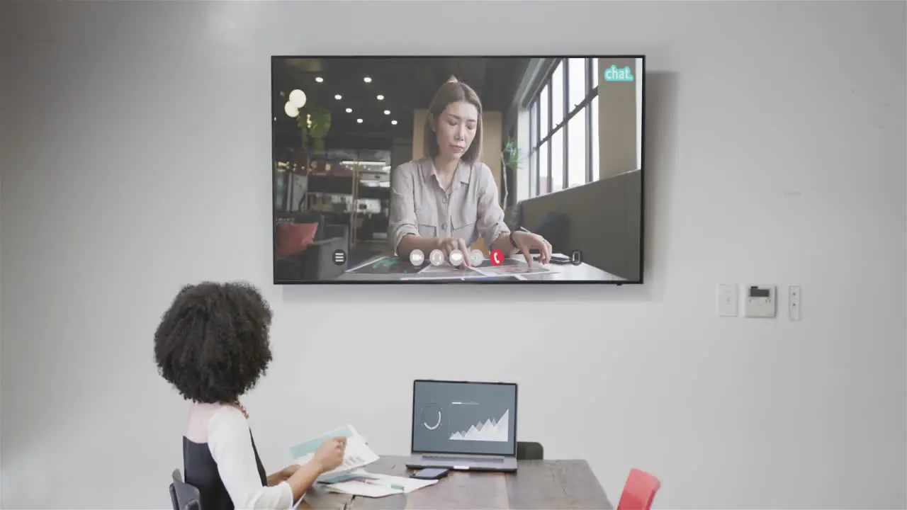 African american businesswoman on video call with caucasian female colleague on screen