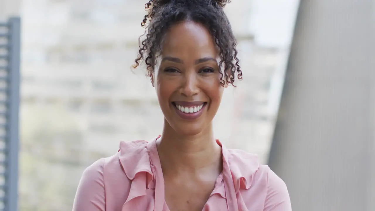 Portrait of happy african american businesswoman in creative office