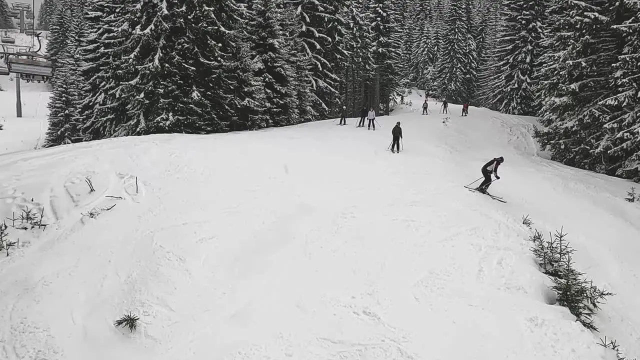 High Angle View Skiers Snowboarders On Snow Covered Mountain From Chair Lift