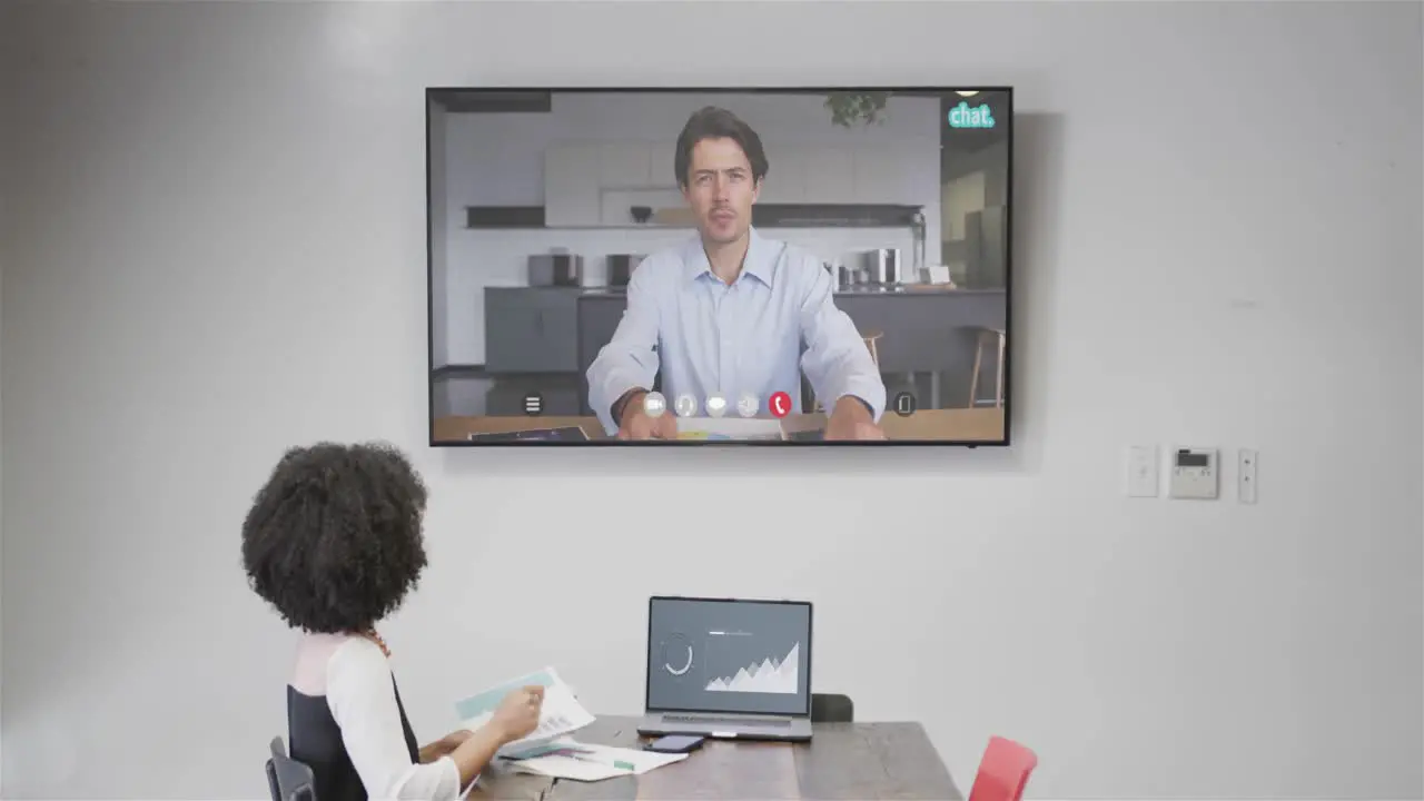 African american businesswoman on video call with caucasian male colleague on screen