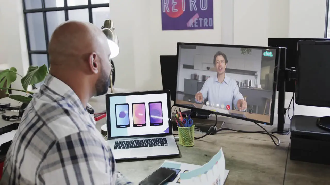 African american businessman on video call with caucasian male colleague on screen