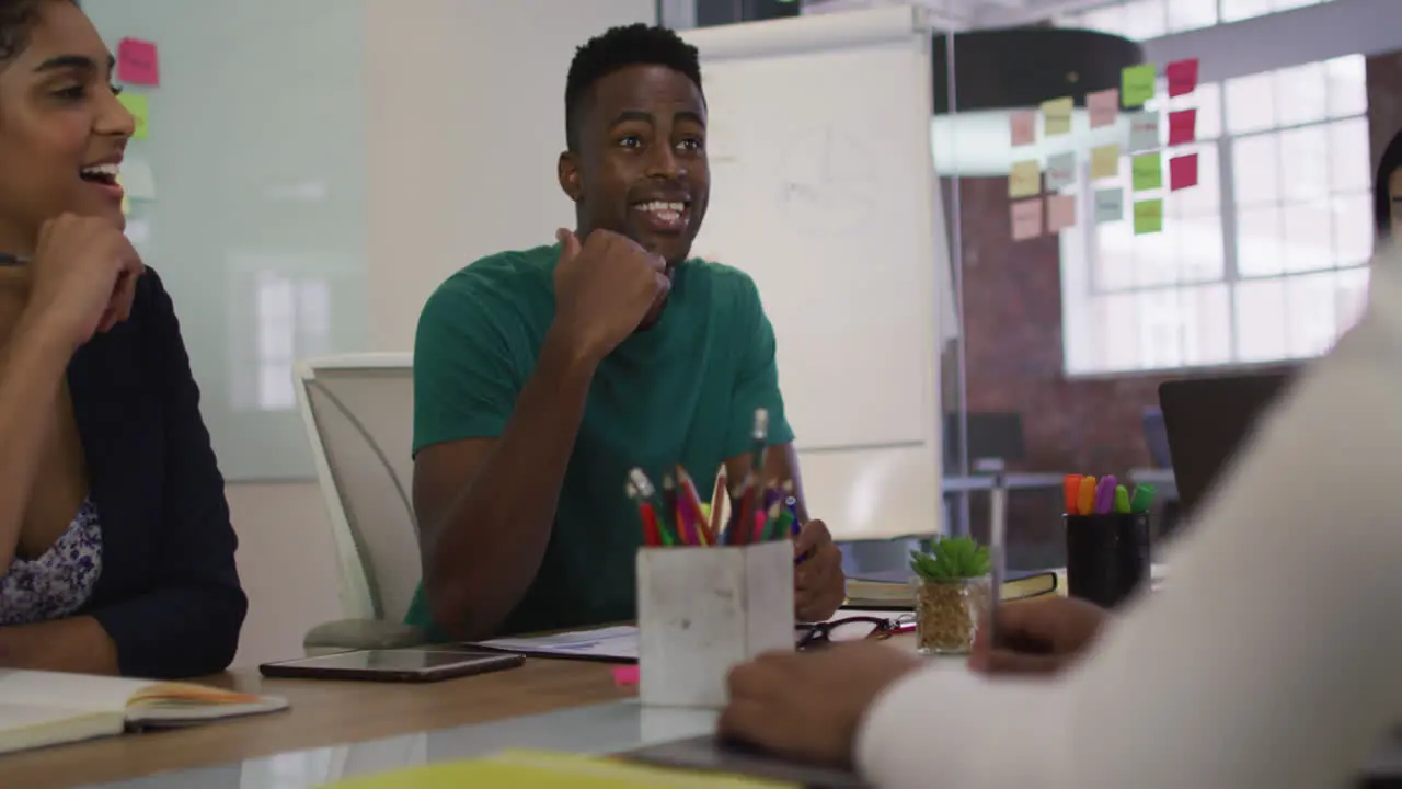 Mixed race business colleagues sitting having a discussion in meeting room