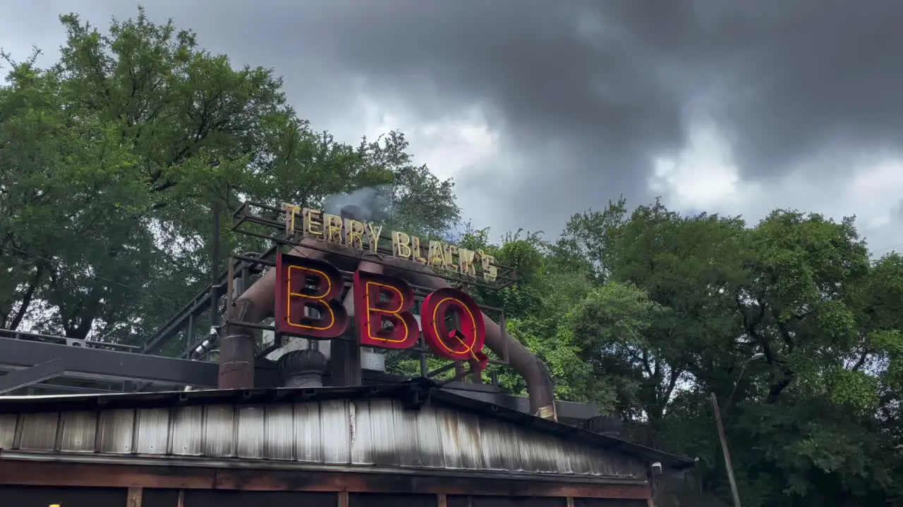 Pedestal Shot of Smoke Emitting from Terry Blacks Texas BBQ on a Cloudy Day in Austin Texas