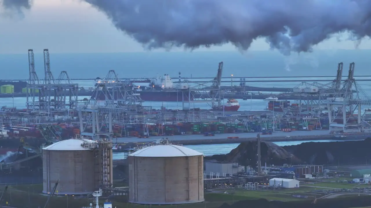 Large cloud of grey smoke bellows across the skyline above Power plant