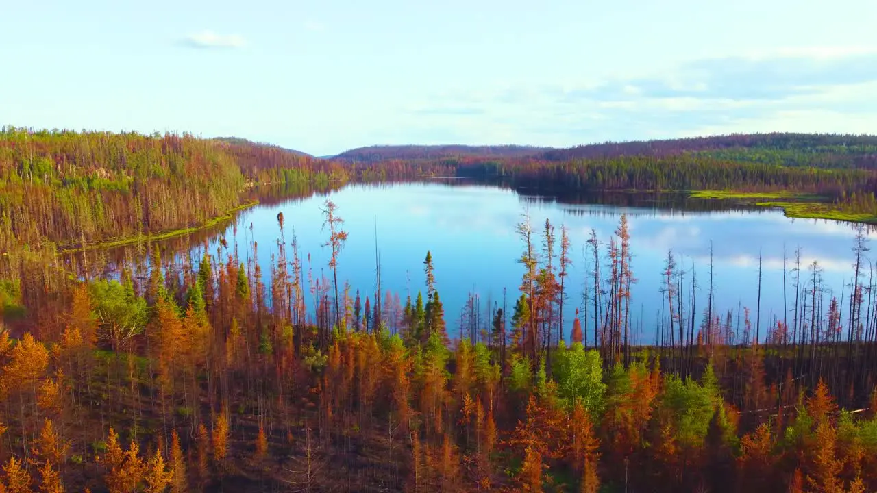 sideways aerial dolly shot showing devastation brought on by Canadian wildfires in the summer