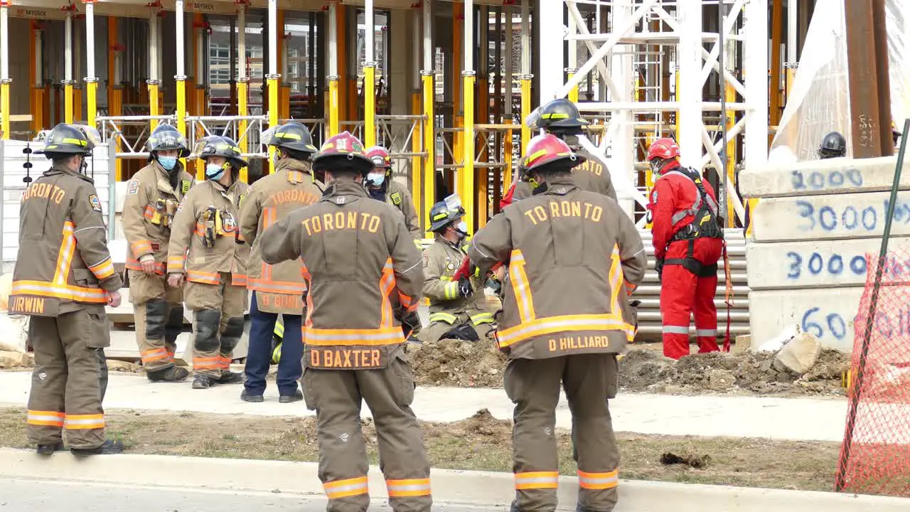 Fire Fighters from Toronto Watching a building under construction at rescue operation still shot