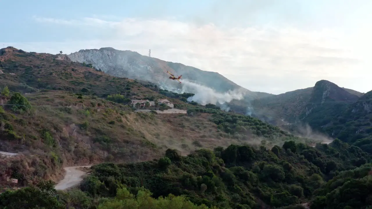 Water-Dropping Plane Fights Wildfire on Hillside