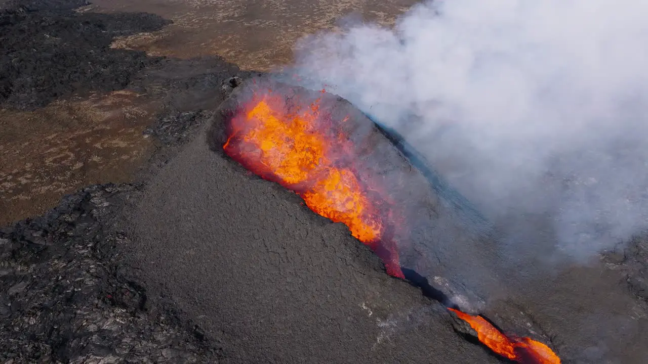 Effusive volcano erupting at earth surface with force lava flowing out aerial