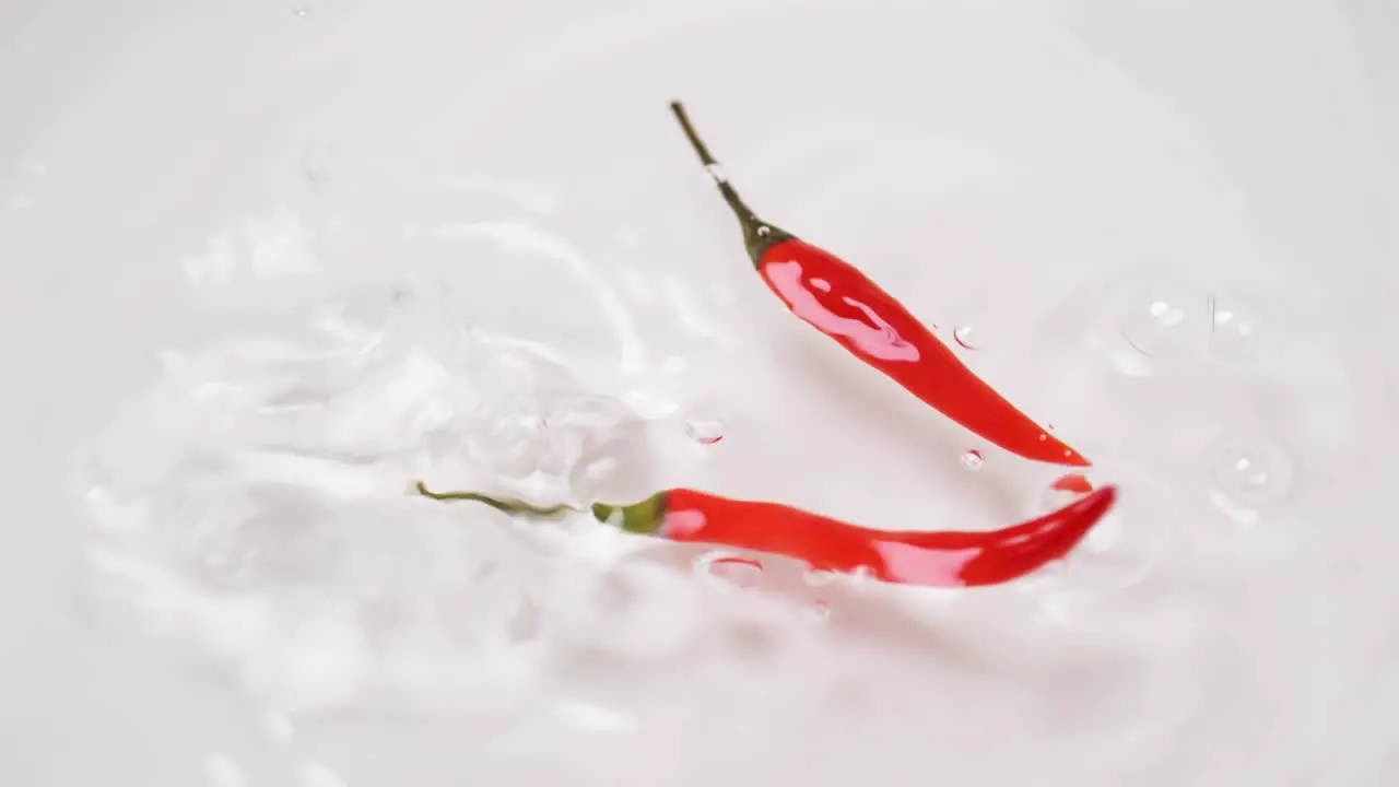 Slow motion of Chili pepper falling on the water surface for sanitization