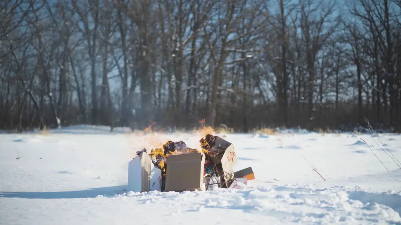 Time-lapse garbage burning in the middle of a field in winter