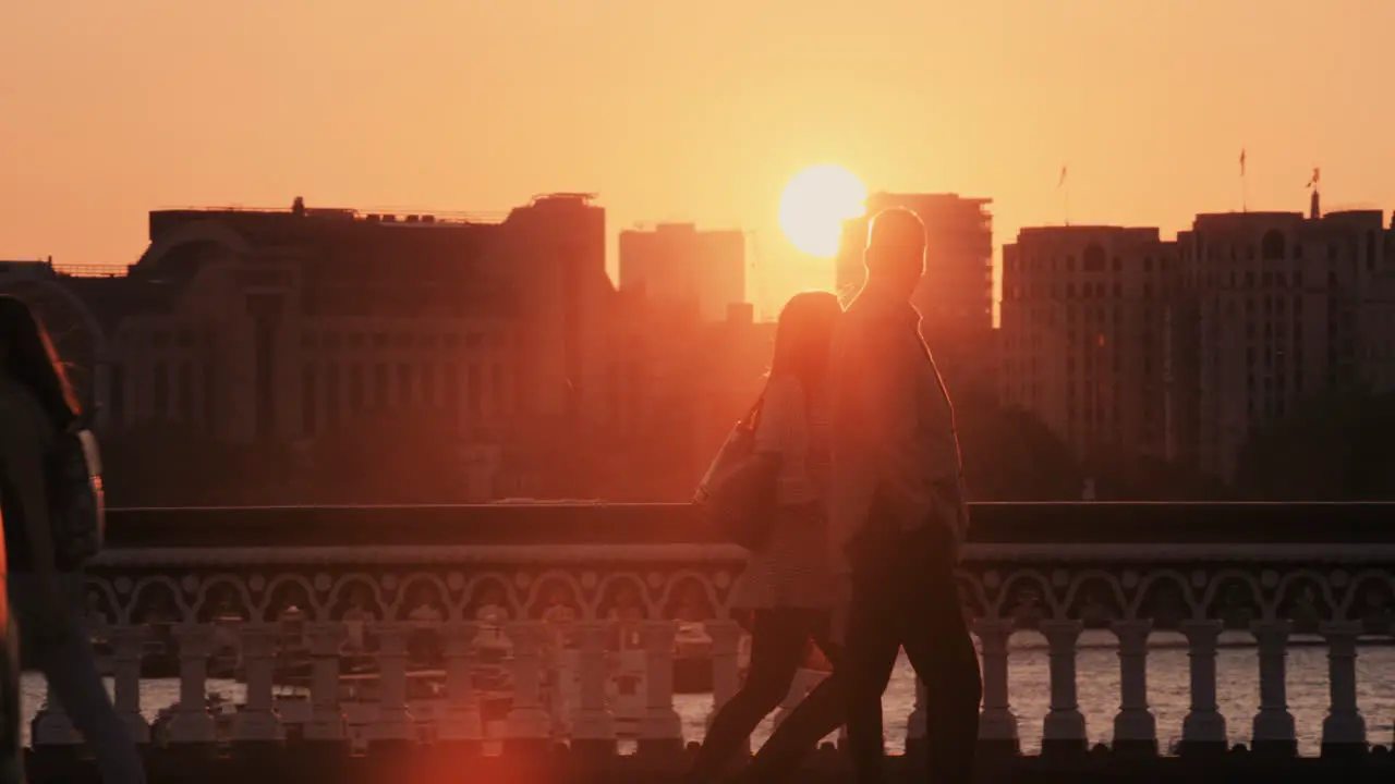 Anonymous crowd of people walking at sunset commuters London City street slow motion